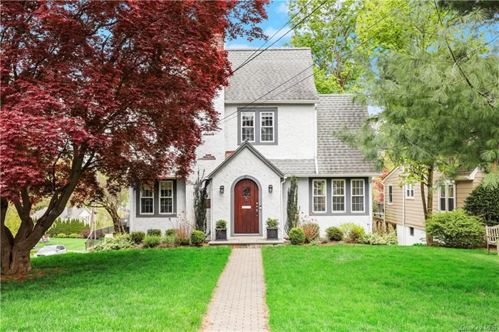 Charming and move-in ready Tudor-style home in the sought-after Rocky Dell neighborhood of White Plains. Enjoy abundant natural light throughout the home set on private corner lot. This property is a perfect blend of classic architecture and tasteful modern updates. Everything is in pristine condition, from the updated kitchen to the renovated baths. Inside, a versatile floor plan is perfect for hosting gatherings with a side door leading to a private patio with a grilling area, perfect for outdoor entertaining. The living room features a cozy fireplace an adjacent sunroom/playroom. The 2nd floor boasts 3 spacious bedrooms and a spacious hall bath with a tub and stall shower. Additional bedroom/ office and recreation space on the 3rd floor, along with plenty of storage. Walk-out basement offers a laundry room, mudroom area, and a large playroom & storage area with easy access to the attached 2-car garage. Minutes to White Plains train station w/38 minute express train to GCS.